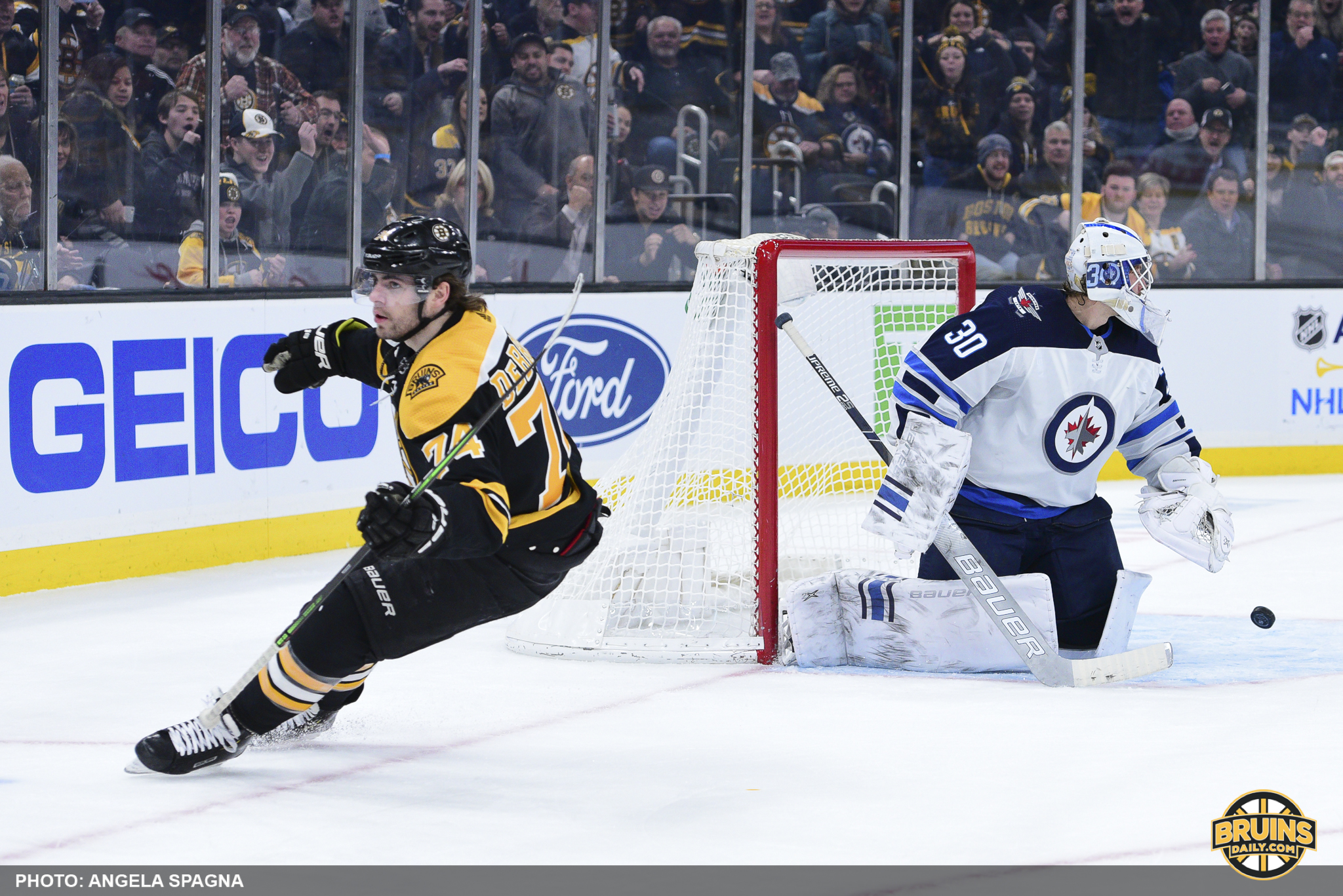 Jake DeBrusk helping Bruins