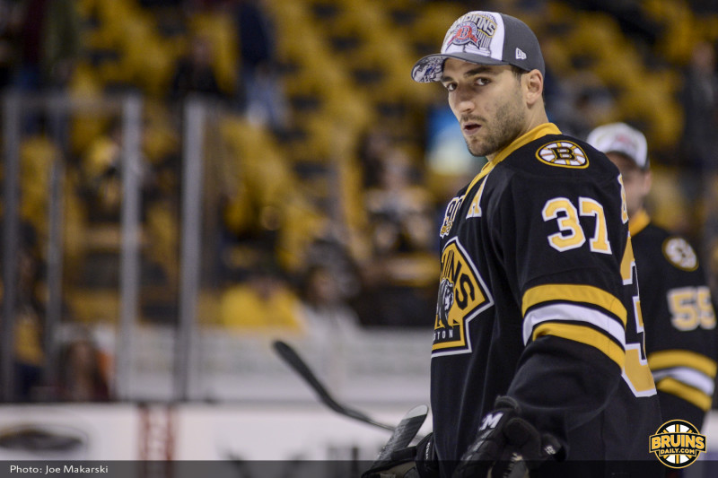 (Photo by Joe Makarski: Bruins Daily) Patrice Bergeron shows off his support for the World Champion Boston Red Sox rocking the World Series hat pre-game. 